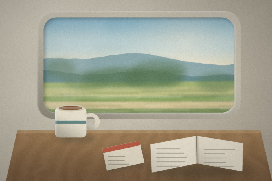 A train window with fields rushing past, a mug and an open book on the table.