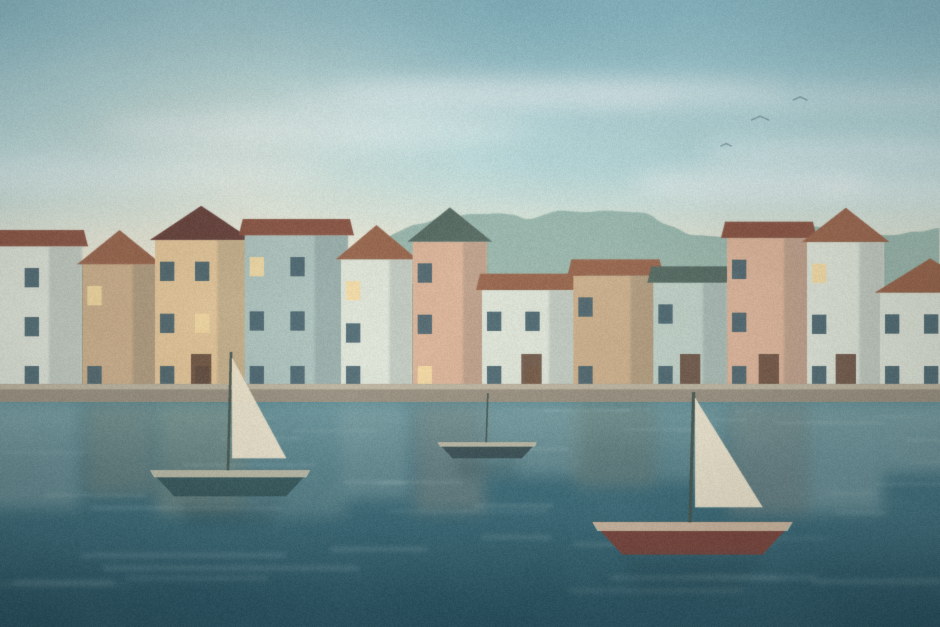 Painted houses along the quay of a small harbour town with moored sailing boats.